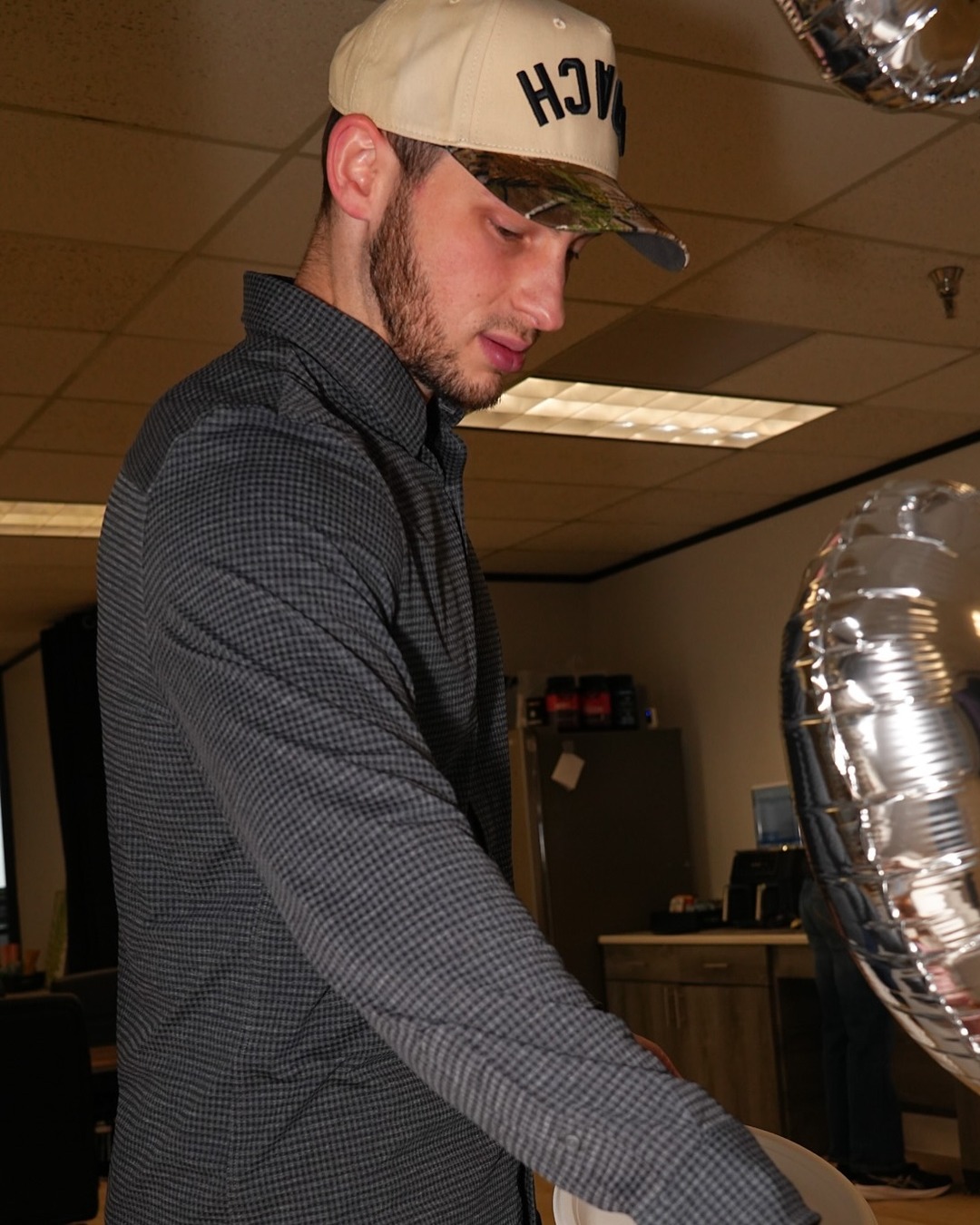 A coach wearing the AR COACH hat