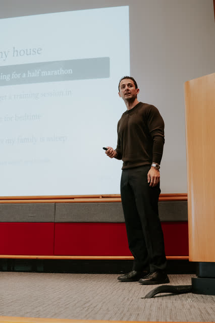 Speaker presenting a talk about family and training on stage