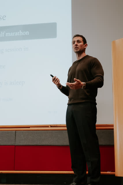 Speaker making a point mid-talk, clicker in hand
