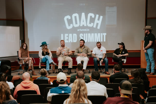 Coaches panel on stage with the host standing to the side