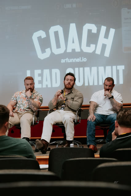 Three panelists in front of the COACH Lead Summit screen, one speaking