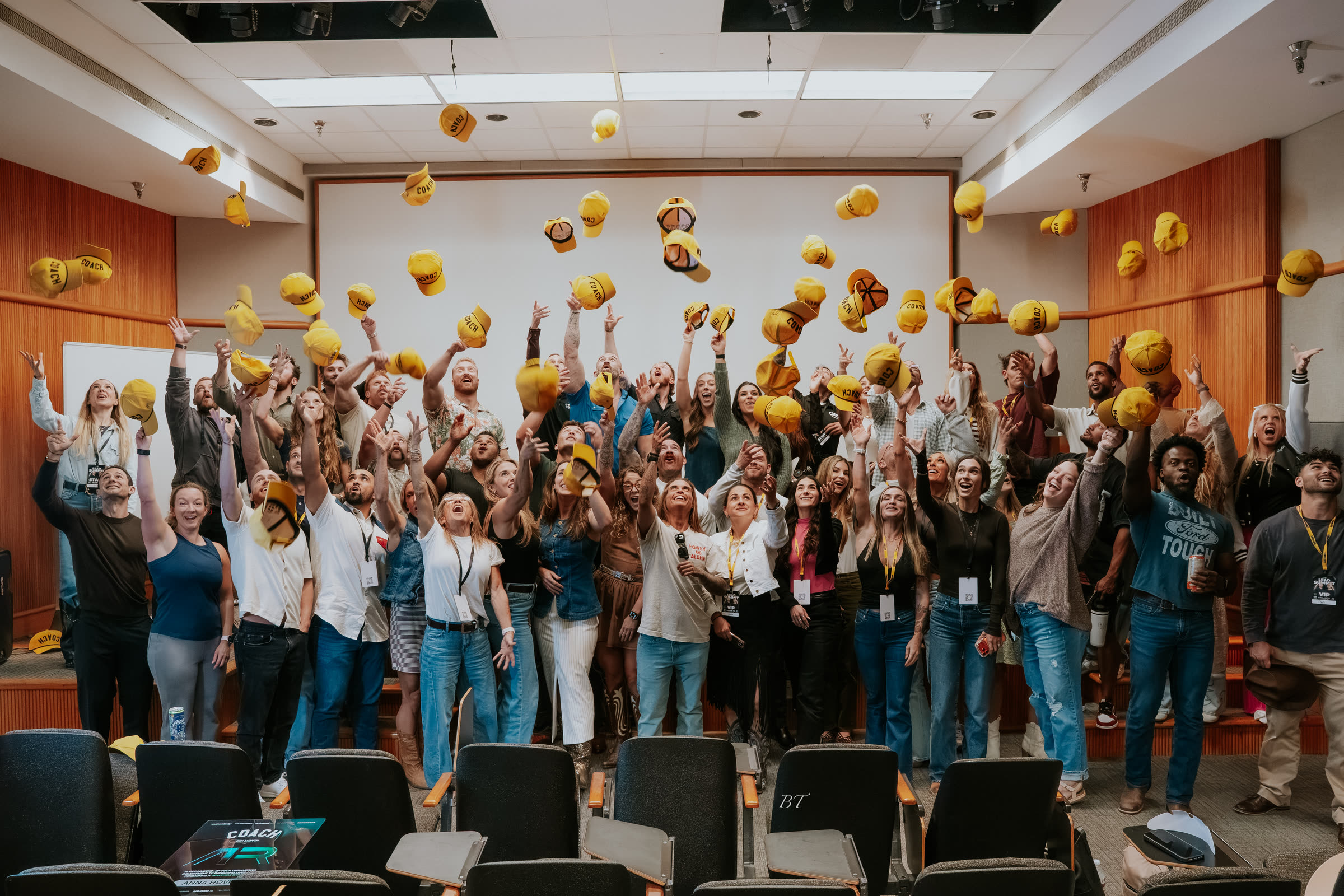 The full room throwing their yellow COACH hats in the air at AR Funnel Lead Summit, October 2026
