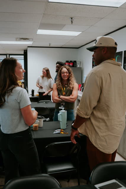Attendees chatting around the tables in the AR office