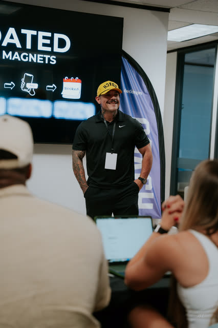 Mike Crowson in a yellow COACH cap presenting a lead magnets slide in the VIP breakout