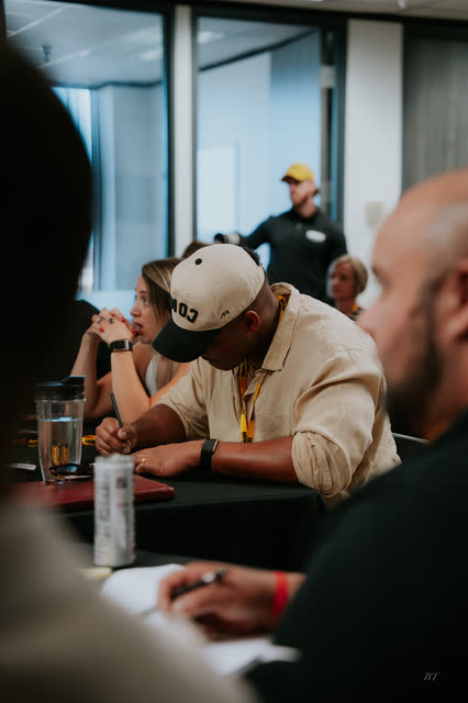 Attendees taking notes at the breakout tables