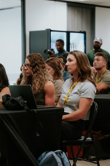 Attendees listening at their laptops during the VIP breakout