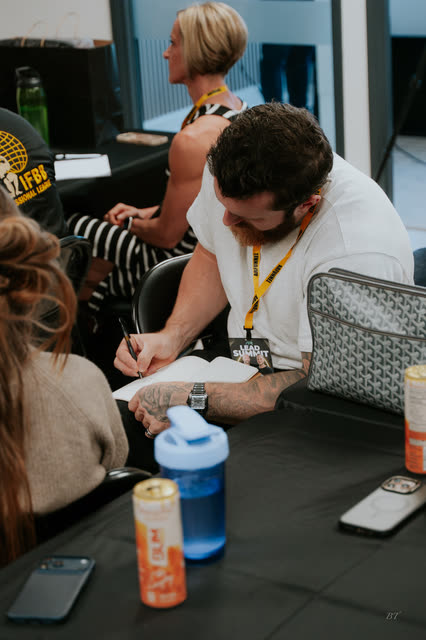 Attendee writing notes by hand during the VIP breakout