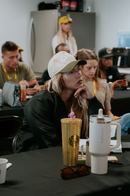 Attendee in a white cap listening during the VIP breakout