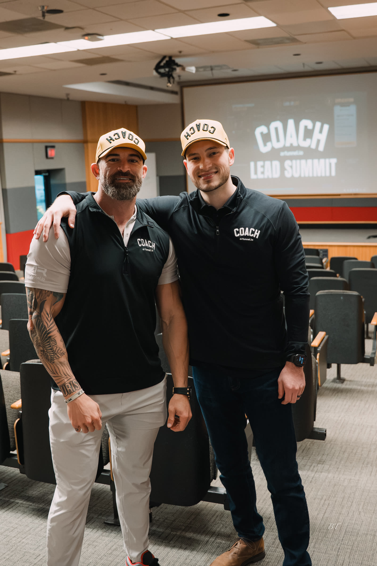 Mike and Bakker under the COACH Lead Summit screen