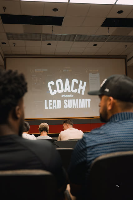Attendees seated under the COACH Lead Summit screen before the first session