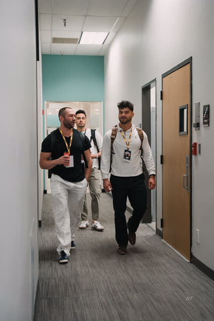 Coaches walking down the hallway to the main hall