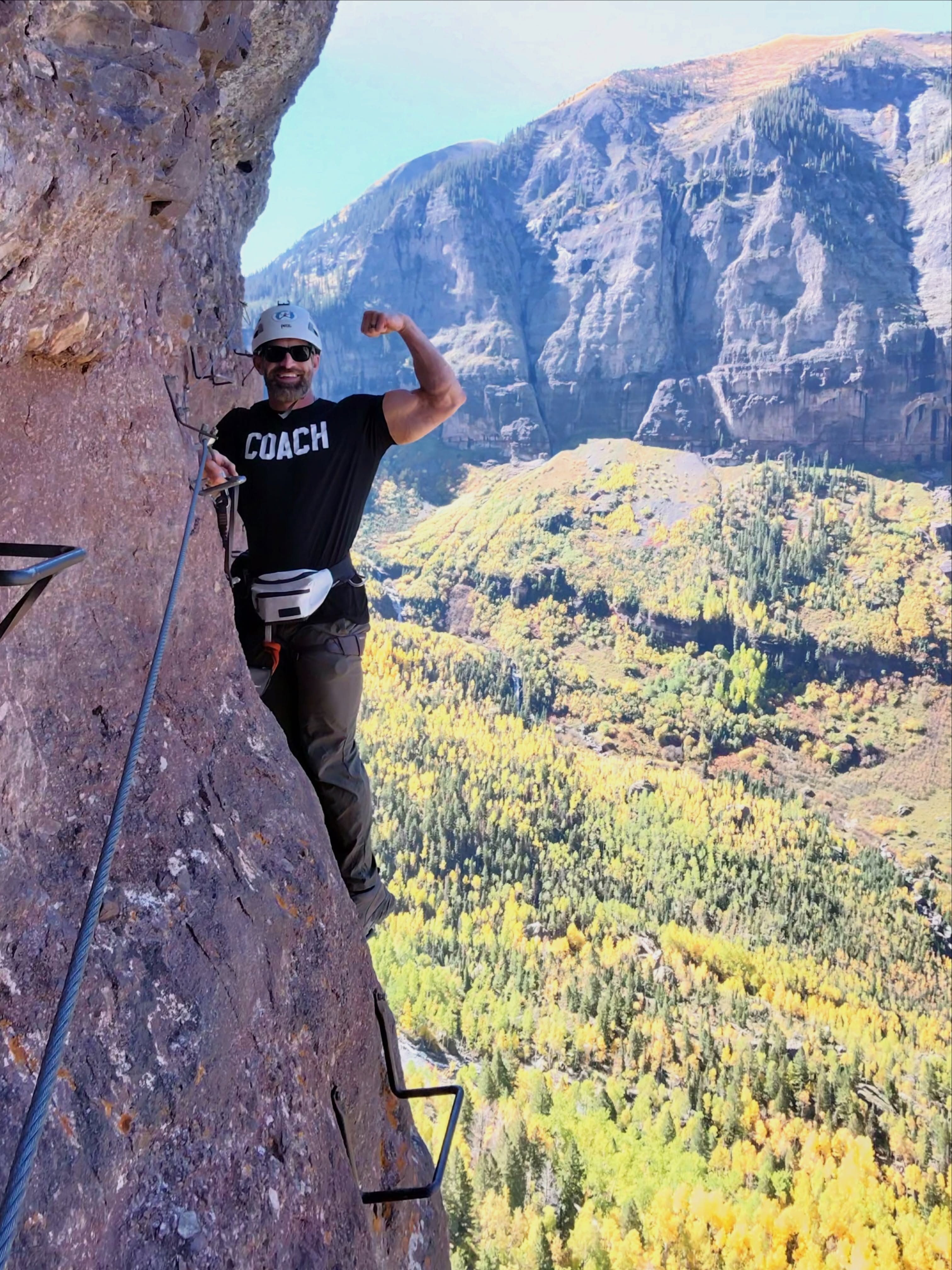 Mike Crowson climbing a via ferrata in the mountains